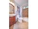 This bathroom features a wood vanity, tiled shower, and updated fixtures at 5028 Jamie Ne Ct, Woodstock, GA 30188