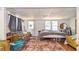 This furnished bedroom features a door to the exterior, two windows, and carpet at 5028 Jamie Ne Ct, Woodstock, GA 30188