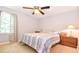 This bedroom offers a window, neutral colors, a ceiling fan, and carpet at 5028 Jamie Ne Ct, Woodstock, GA 30188