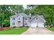 Charming two-story home boasts a well-manicured lawn, inviting entrance, and a convenient two-car garage at 5028 Jamie Ne Ct, Woodstock, GA 30188