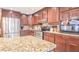 A modern kitchen boasts stainless steel appliances, rich wood cabinets, and granite countertops at 5028 Jamie Ne Ct, Woodstock, GA 30188