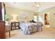 Spacious main bedroom featuring tray ceilings, neutral carpet, and an ensuite bathroom at 5028 Jamie Ne Ct, Woodstock, GA 30188