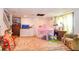 This playroom offers a doll house, desk, television, and rug at 5028 Jamie Ne Ct, Woodstock, GA 30188