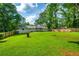 Large backyard with green grass and privacy fence at 120 Lakeside Dr, Ellenwood, GA 30294