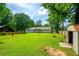 View of backyard with lush lawn, wooden fence and patio with pergola at 120 Lakeside Dr, Ellenwood, GA 30294