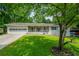 Inviting single-story home with a well-manicured lawn and attached garage at 120 Lakeside Dr, Ellenwood, GA 30294