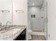 Bathroom featuring a modern vanity with granite counters and a glass enclosed shower with mosaic tile at 4417 Village Square Ln, Stone Mountain, GA 30083