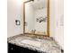 Well-lit bathroom features a striking granite countertop and sleek fixtures at 4417 Village Square Ln, Stone Mountain, GA 30083