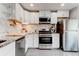 Modern kitchen with white cabinets, stainless steel appliances, and granite countertops at 4417 Village Square Ln, Stone Mountain, GA 30083
