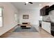 Open-concept kitchen and living area with wood floors and abundant natural light at 4417 Village Square Ln, Stone Mountain, GA 30083