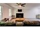 Spacious living room featuring a modern fireplace, ceiling fan, and lots of natural light at 4417 Village Square Ln, Stone Mountain, GA 30083