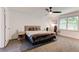 This is a comfortable bedroom that features a ceiling fan, neutral colors, and lots of natural light at 4417 Village Square Ln, Stone Mountain, GA 30083