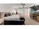 This main bedroom boasts a ceiling fan, natural light, and an adjacent bathroom with a barn door at 4417 Village Square Ln, Stone Mountain, GA 30083