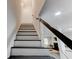 Staircase with modern railing leading to the upper level at 4417 Village Square Ln, Stone Mountain, GA 30083