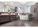 This is a modern bathroom with double sinks, a soaking tub, and a tiled shower at 1260 Monroe Ne Dr, Atlanta, GA 30306