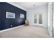 Cozy bedroom with blue accent wall and access to an outdoor balcony at 1260 Monroe Ne Dr, Atlanta, GA 30306