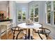 Bright breakfast nook with large windows and a stylish round table at 1260 Monroe Ne Dr, Atlanta, GA 30306
