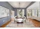 Spacious dining room with hardwood floors, large windows, and stylish furniture at 1260 Monroe Ne Dr, Atlanta, GA 30306