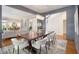 Open-concept dining area with a view of the living room and staircase, illuminated by a modern chandelier at 1260 Monroe Ne Dr, Atlanta, GA 30306
