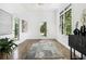 Bright, spacious foyer boasts elegant tile flooring, statement rug, modern lighting, and ample natural light at 1260 Monroe Ne Dr, Atlanta, GA 30306