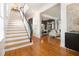 Open-concept foyer with hardwood floors, elegant staircase, and seamless flow into the adjoining living room at 1260 Monroe Ne Dr, Atlanta, GA 30306