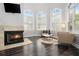 Bright living room featuring a fireplace, hardwood floors, and multiple windows at 1260 Monroe Ne Dr, Atlanta, GA 30306