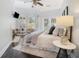 Bright main bedroom featuring high ceilings, a fireplace, and a seating area near the window at 1260 Monroe Ne Dr, Atlanta, GA 30306