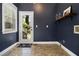 Cozy mud room with a window, access to the backyard, and dark blue accent wall at 1260 Monroe Ne Dr, Atlanta, GA 30306