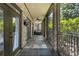 Covered porch featuring brick columns, slate tile flooring, ceiling fan, and comfortable seating, perfect for outdoor living at 1260 Monroe Ne Dr, Atlanta, GA 30306