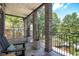 Inviting outdoor porch with stone columns, stylish furniture, and lush greenery, ideal for relaxation and enjoying views at 1260 Monroe Ne Dr, Atlanta, GA 30306