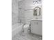 Bathroom with marble flooring and tile, shower-tub combo, new vanity and lighting at 1585 Olympian Sw Cir, Atlanta, GA 30310