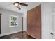 Bedroom featuring a brick wall, dark ceiling fan, and window at 1585 Olympian Sw Cir, Atlanta, GA 30310