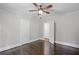 Bedroom with hardwood floors featuring attached bathroom and closet with white doors at 1585 Olympian Sw Cir, Atlanta, GA 30310