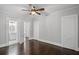 Bedroom with hardwood floors featuring attached bathroom and closet with white doors at 1585 Olympian Sw Cir, Atlanta, GA 30310