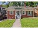 Charming brick home featuring a cozy front porch and well-manicured lawn at 1585 Olympian Sw Cir, Atlanta, GA 30310