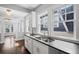 Updated kitchen features stainless steel sink, white cabinets, and a modern faucet at 1585 Olympian Sw Cir, Atlanta, GA 30310