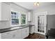 The updated kitchen offers white cabinets, dark countertops and stainless steel appliances at 1585 Olympian Sw Cir, Atlanta, GA 30310