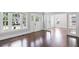 Bright living room featuring hardwood floors, neutral paint, and an open doorway at 1585 Olympian Sw Cir, Atlanta, GA 30310
