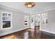 Spacious living area with hardwood floors and large windows offers views to the connected kitchen at 1585 Olympian Sw Cir, Atlanta, GA 30310