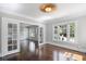 Bright living room features hardwood floors, large windows and charming overhead lighting at 1585 Olympian Sw Cir, Atlanta, GA 30310