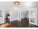 Open-concept space featuring hardwood floors, gray walls, white trim, and ample natural light at 1585 Olympian Sw Cir, Atlanta, GA 30310