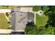 Aerial view of home featuring a stone patio with a built-in firepit, professional landscaping, and a well-maintained roof at 2545 Tilson Se Dr, Atlanta, GA 30317