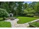 Backyard features a fire pit area, mature trees, and lush landscaping for a private outdoor oasis at 2545 Tilson Se Dr, Atlanta, GA 30317