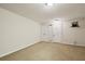 Unfinished basement features neutral carpet, bright lights and an electric wall mount at 2545 Tilson Se Dr, Atlanta, GA 30317