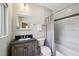 Well lit bathroom with marble tiling, vanity, and a shower and tub combination at 2545 Tilson Se Dr, Atlanta, GA 30317