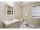 Elegant bathroom with white marble floors, custom vanity with storage, and a framed mirror at 2545 Tilson Se Dr, Atlanta, GA 30317