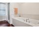 Relaxing bathroom with a soaking tub, tiled walls, and a separate walk-in shower at 2545 Tilson Se Dr, Atlanta, GA 30317