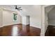 Bright bedroom with hardwood floors, ceiling fan, and a view of the outdoor landscape at 2545 Tilson Se Dr, Atlanta, GA 30317
