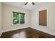 Well-lit bedroom featuring hardwood floors and windows overlooking the outdoor scenery at 2545 Tilson Se Dr, Atlanta, GA 30317