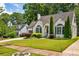 Charming home featuring a brick facade, manicured lawn, and lush landscaping at 2545 Tilson Se Dr, Atlanta, GA 30317